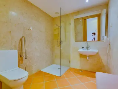 a bathroom with a toilet and a sink at AL - Apartamento Vila Sol Adaptado in Vilamoura