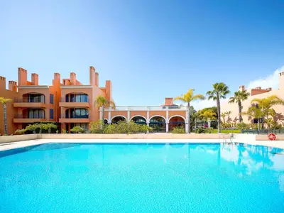 a large swimming pool in front of a building at AL - Apartamento Vila Sol Adaptado in Vilamoura