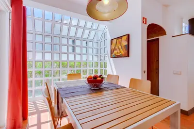 a dining room table with a bowl of fruit on it at AL - Moradia Vila Brasil in Vilamoura