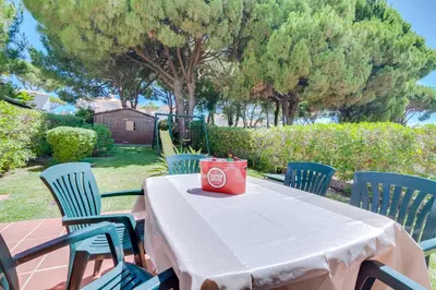 a table and chairs with a red container on it at AL - Moradia Vila Brasil in Vilamoura