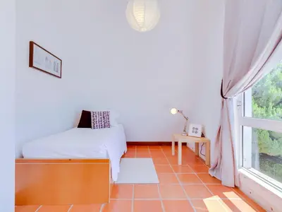 a bedroom with a bed and a window at AL - Moradia Vila Brasil in Vilamoura