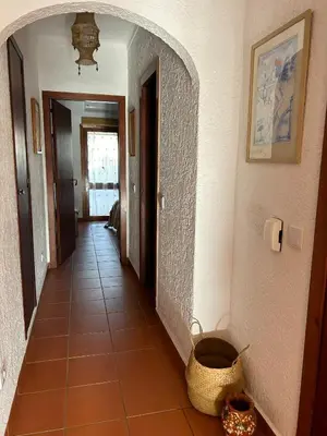 a hallway of a house with a basket on the floor at Ouramar Apartment in Albufeira
