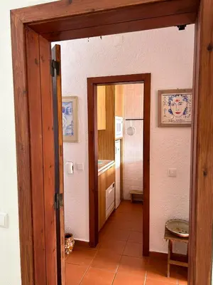 a hallway with a door open to a kitchen at Ouramar Apartment in Albufeira