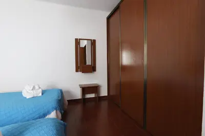 a bedroom with a bed and a mirror and a closet at Apartamento Brisa Mar in Albufeira