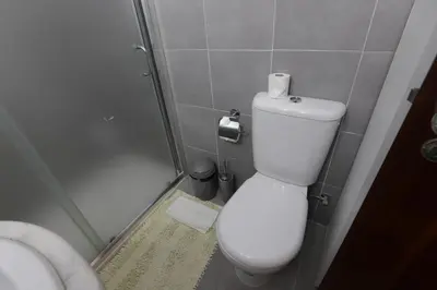 a small bathroom with a toilet and a shower at Apartamento Brisa Mar in Albufeira