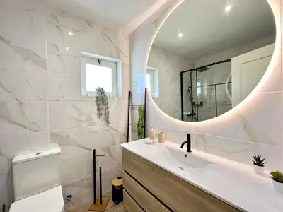 a bathroom with a sink and a mirror at Vilamoura Brightness Villa With Pool by Homing in Vilamoura