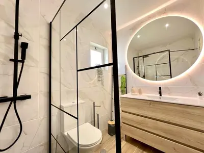 a bathroom with a toilet and a mirror at Vilamoura Brightness Villa With Pool by Homing in Vilamoura