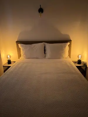 a bedroom with a bed and a large curtain at Romeu in Quarteira