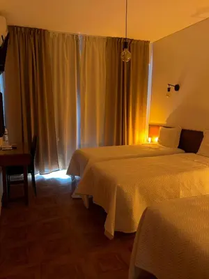 a bed with white sheets and pillows in a bedroom at Romeu in Quarteira