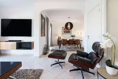 a living room with leather chairs and a flat screen tv at Villa Verde by IntiHolidays in Guia