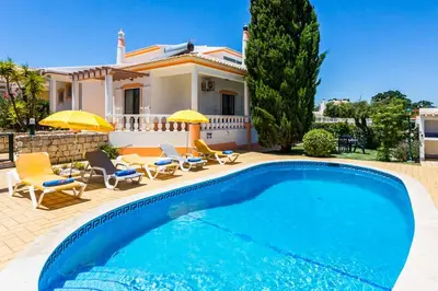 a villa with a swimming pool in front of a house at Villa Bonita Gale in Galé