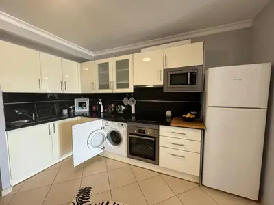 a kitchen with white cabinets and a white refrigerator at Villa Martin in Albufeira