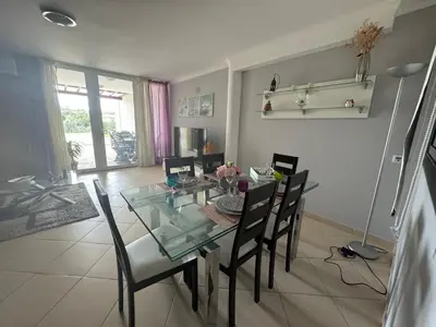 a dining room with a glass table and chairs at Villa Martin in Albufeira