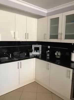 a kitchen with white cabinets and a microwave at Villa Martin in Albufeira