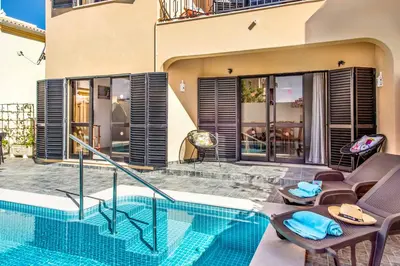 a house with a swimming pool next to a building at Villa Timoneiro in Galé