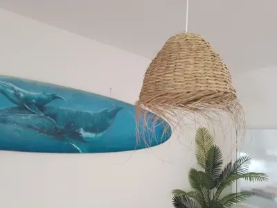 a picture of a fish on a surfboard at BEACH HOUSE in Olhos de Água