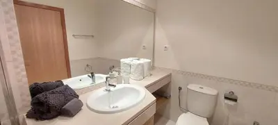 a bathroom with a sink and a toilet and a mirror at Apartment Lucia Albufeira in Olhos de Água
