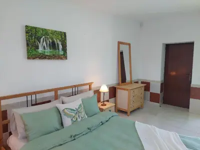 a bedroom with a bed and a dresser and a lamp at Villa Lucia, Olhos D'Agua, Albufeira in Albufeira
