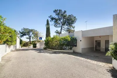 an empty driveway in front of a white building at Casa Mila by Sunnyway in Olhos de Água