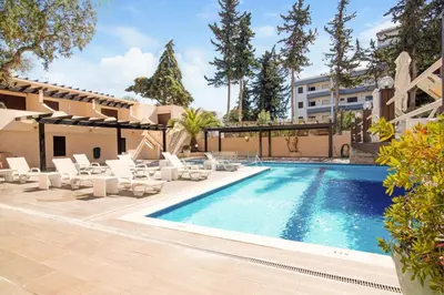 a swimming pool with lounge chairs and a building at Casa Mila by Sunnyway in Olhos de Água