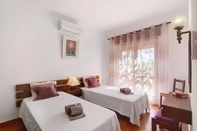 a room with two beds and a window at Casa Mila by Sunnyway in Olhos de Água