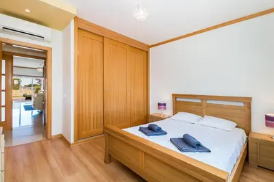 a bedroom with a bed with two blue towels on it at Apartamento albufeira cerro da águia in Albufeira