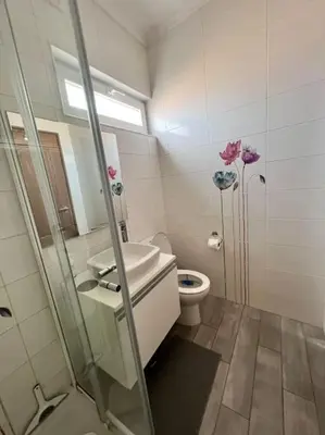 a bathroom with a toilet and a sink and a shower at Typical quiet Algarve cottage in Faro