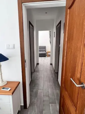 a hallway with a door and a room with a couch at Typical quiet Algarve cottage in Faro