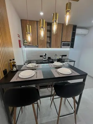 a dining room with a table with chairs and glasses at Comfy Home in Albufeira