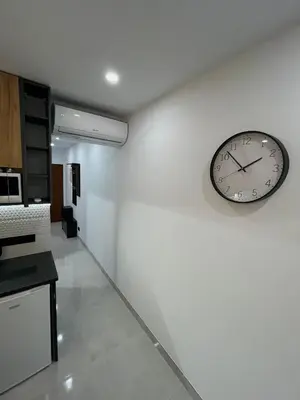 a clock on a white wall in a kitchen at Comfy Home in Albufeira