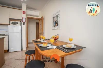 a kitchen with a table with two glasses of orange juice at #201 Families Only - Quinta da Flor in Albufeira