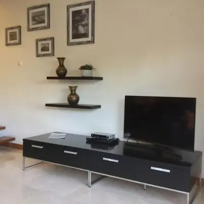 a living room with a flat screen tv on a table at Apartment Rosmaninho-Hosted by Sweetstay in Quarteira