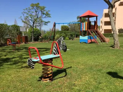 a park with a playground with a swing at Apartment Rosmaninho-Hosted by Sweetstay in Quarteira
