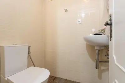 a bathroom with a toilet and a sink at Algarvian Experience - Sun, Beach and Pool in Albufeira