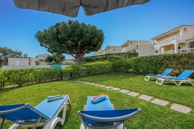 a group of chairs sitting on the grass in a yard at Meadow View Retreat in Albufeira