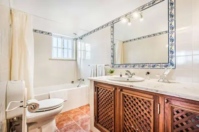 a bathroom with a toilet and a sink and a tub at Villa Barrancos in Guia