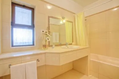 a bathroom with a sink and a tub and a window at Villa Mirasol - Relaxed Private Villa in Albufeira