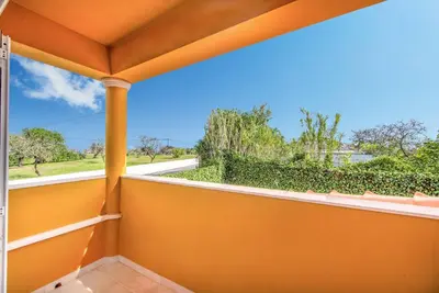 an orange balcony with a view of a street at Villa Godinho in Albufeira