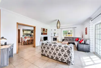 a living room with a couch and a table at Villa Godinho in Albufeira