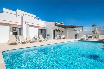 a swimming pool in front of a villa at Villa Catarino in Albufeira