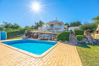 a house with a swimming pool in the yard at Villa Gabie in Albufeira