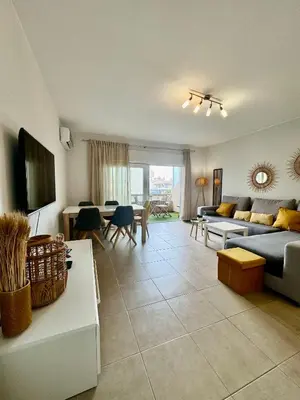 a living room with a couch and a table at Why Knot Beach, Marina Nearby in Quarteira