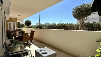 a balcony with a white wall and a table and chairs at Harmony by Check-in Portugal in Albufeira