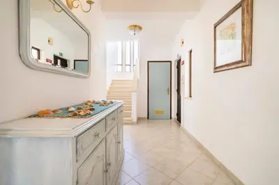 a bathroom with a sink and a mirror and a hallway at Villa Palmeiras - Serene Private Villa in Albufeira
