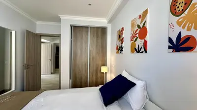 a bedroom with a bed and paintings on the wall at Hibisco 1 by Check-in Portugal in Albufeira