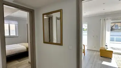 a mirror in a room with a bed and a bedroom at Hibisco 1 by Check-in Portugal in Albufeira