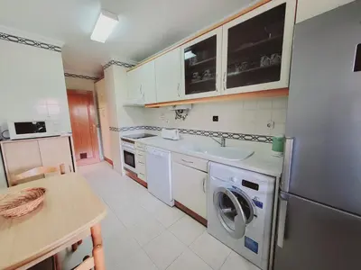 a kitchen with a washing machine and a sink at Varandas do Sol by Garvetur in Vilamoura