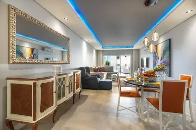 a living room with a dining table and a mirror at Varandas do Sol by Garvetur in Vilamoura
