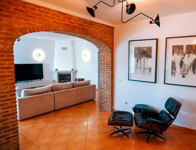 a living room with a couch and chairs and a fireplace at Villa Miracampo - Elegant Secret in Albufeira