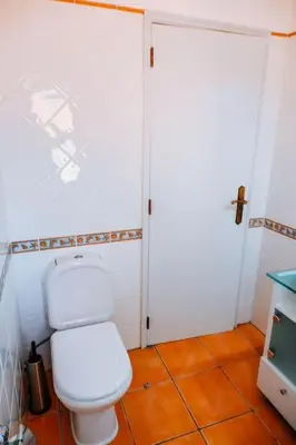 a bathroom with a white toilet in a room at Villa Miracampo - Elegant Secret in Albufeira